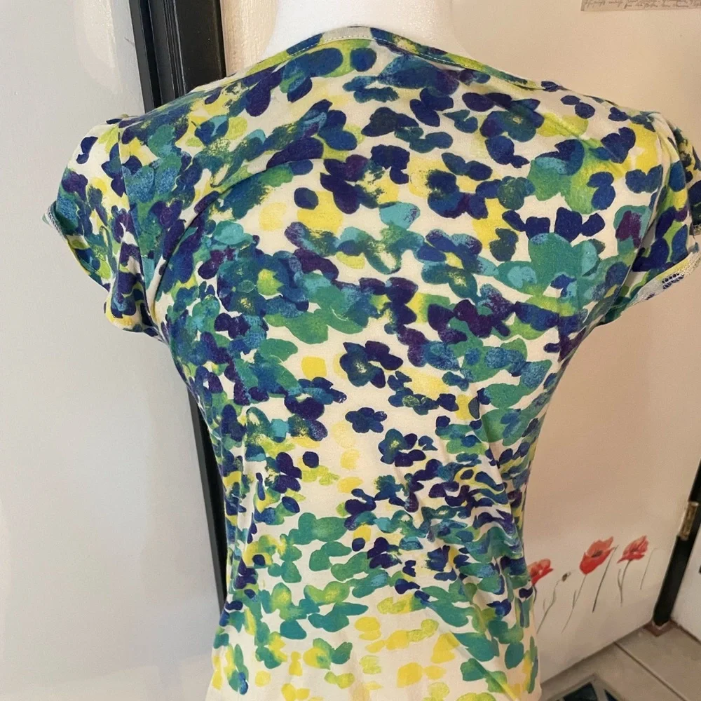 Cream shirt with blues and greens that resemble leaves on a cap sleeve shirt - Picture 6 of 8
